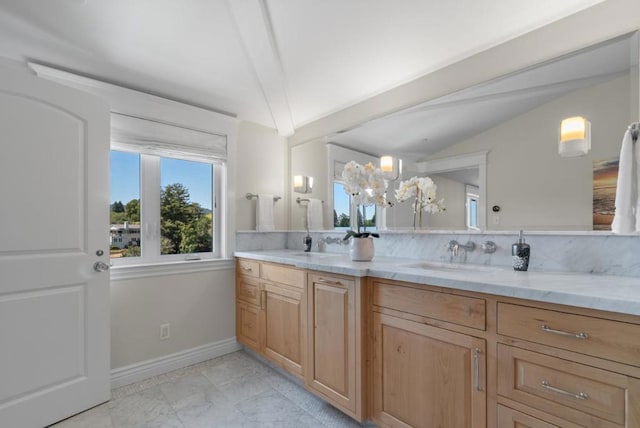 bathroom with vanity and lofted ceiling