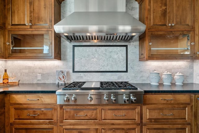 kitchen with decorative backsplash, stainless steel gas cooktop, and wall chimney exhaust hood