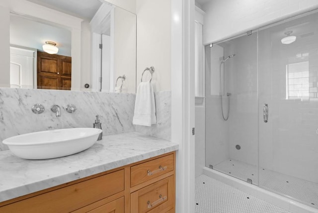 bathroom with decorative backsplash, an enclosed shower, vanity, tile walls, and tile patterned flooring