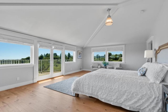 bedroom featuring hardwood / wood-style floors, lofted ceiling with beams, and access to outside