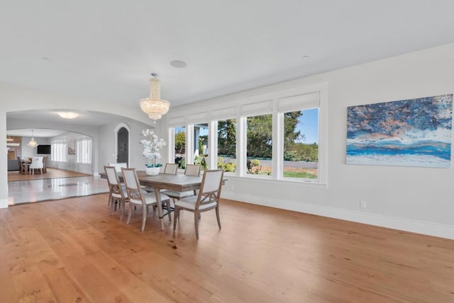 dining room featuring an inviting chandelier and light hardwood / wood-style flooring