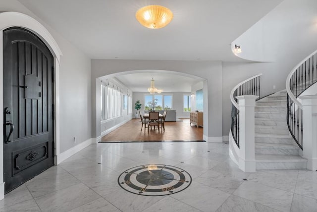 foyer with an inviting chandelier