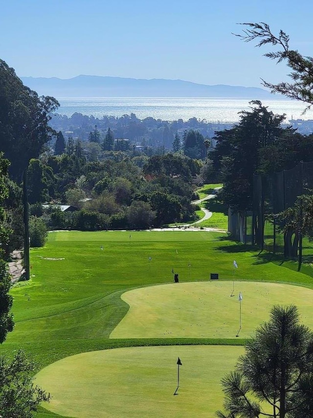 surrounding community featuring a mountain view and a yard