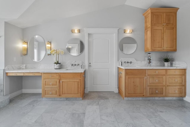 bathroom with vanity and vaulted ceiling