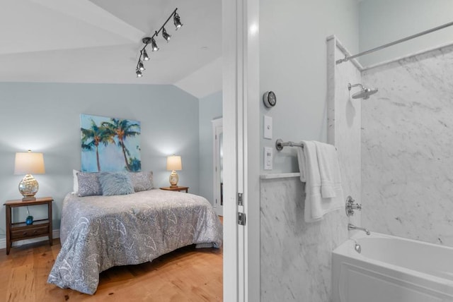 bedroom featuring hardwood / wood-style floors and vaulted ceiling