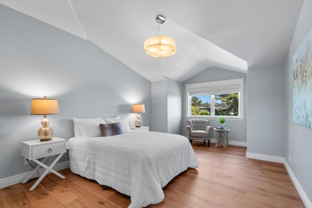 bedroom with hardwood / wood-style flooring and vaulted ceiling