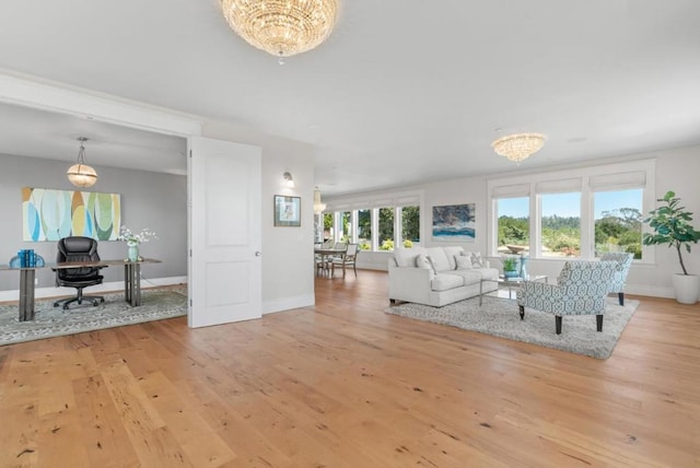 living room featuring light hardwood / wood-style floors and an inviting chandelier