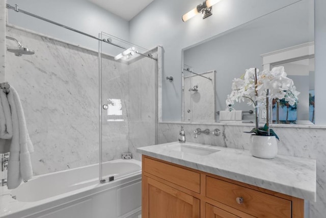 bathroom featuring vanity and shower / bath combination with glass door