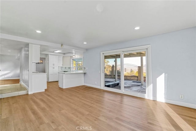 unfurnished living room with light wood-type flooring