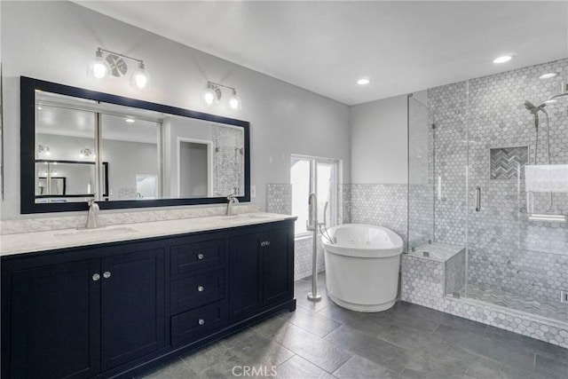 bathroom with tile walls, tile patterned floors, vanity, and independent shower and bath