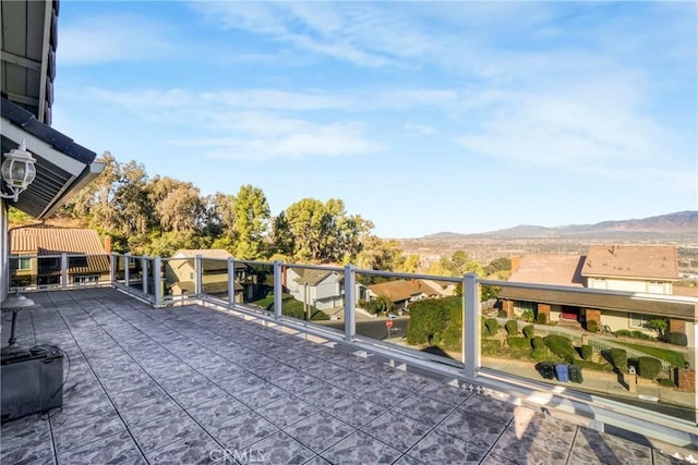 view of patio with a balcony and a mountain view