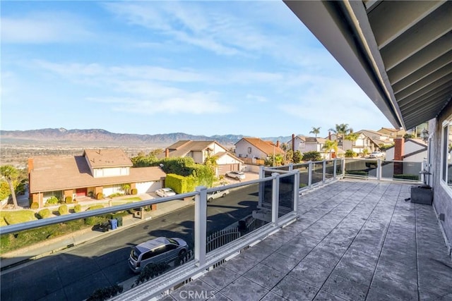 view of patio featuring a mountain view and a balcony