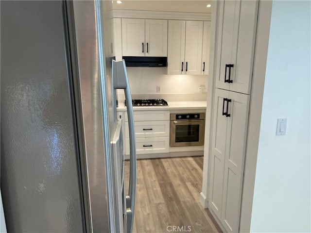 kitchen featuring white cabinetry, stainless steel appliances, and light hardwood / wood-style flooring