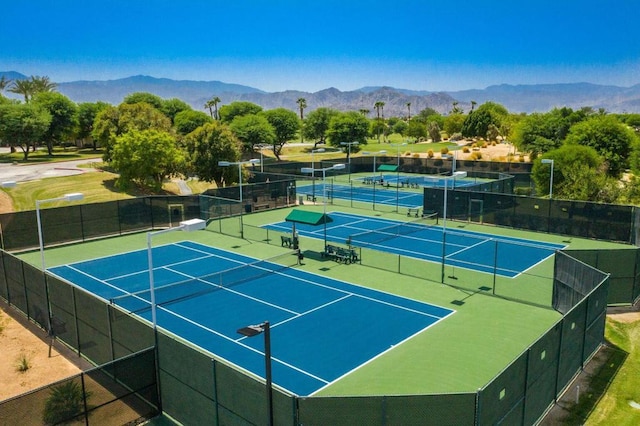 view of sport court with a mountain view and basketball court