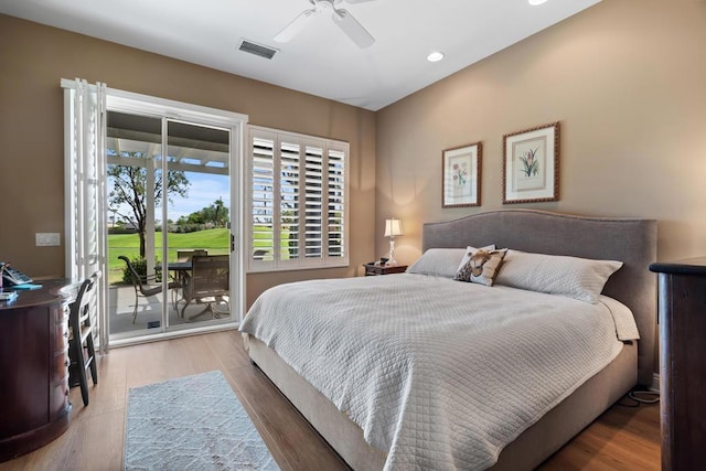 bedroom featuring hardwood / wood-style floors, ceiling fan, and access to exterior