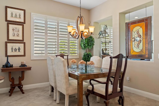 tiled dining room featuring a chandelier