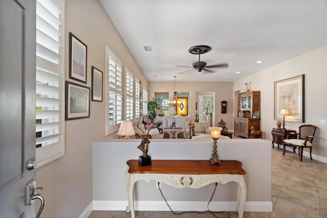 tiled living room featuring ceiling fan