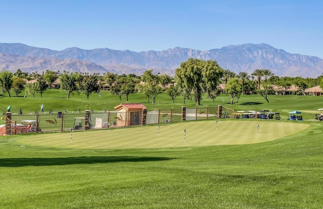 view of property's community with a mountain view and a yard