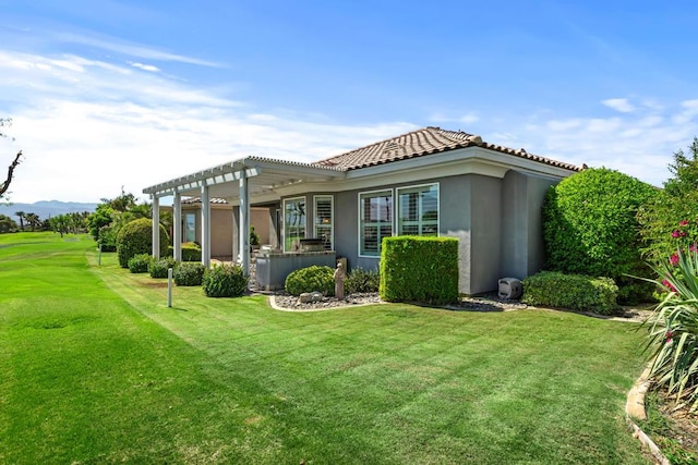 back of house featuring a pergola and a yard