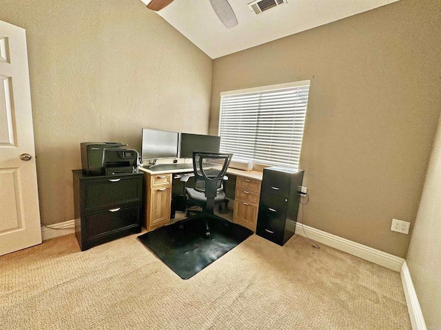 carpeted office space featuring vaulted ceiling and ceiling fan