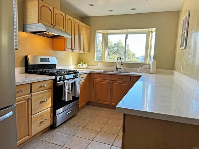 kitchen featuring light tile patterned floors, stainless steel appliances, and sink