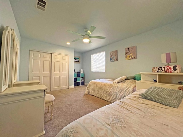 bedroom with a closet, carpet flooring, and ceiling fan