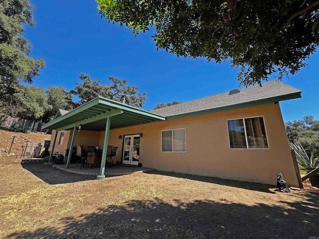 rear view of house featuring french doors and a patio