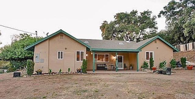 rear view of house with a patio