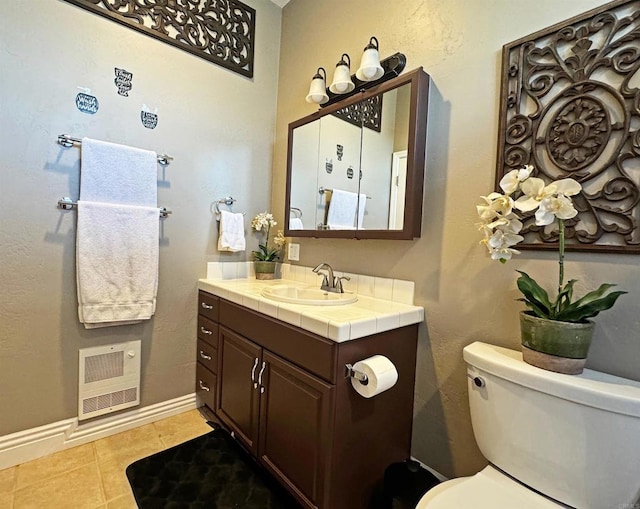 bathroom featuring vanity, toilet, tile patterned floors, and heating unit