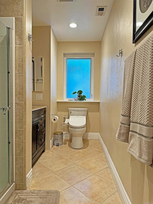 bathroom with vanity, tile patterned floors, toilet, and walk in shower