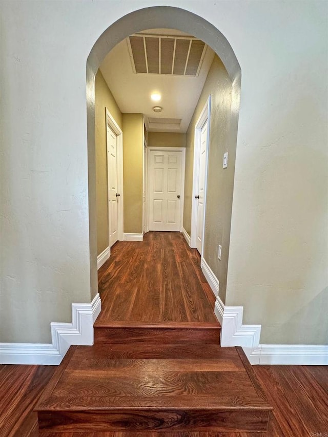 hallway with dark hardwood / wood-style floors