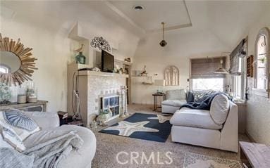 carpeted living room with vaulted ceiling