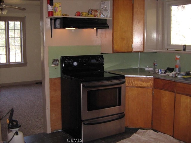 kitchen featuring ceiling fan, extractor fan, dark tile patterned flooring, and black range with electric cooktop