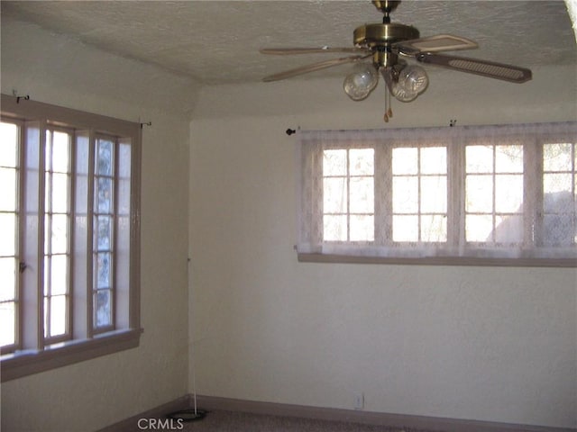 unfurnished room featuring a textured ceiling and ceiling fan