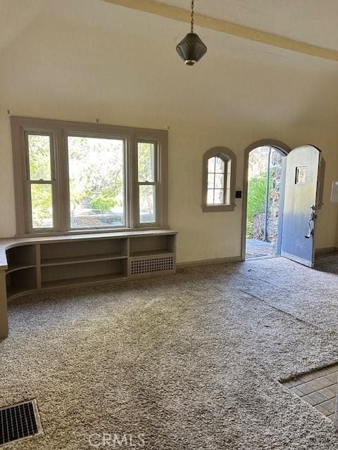 unfurnished living room featuring carpet flooring and lofted ceiling