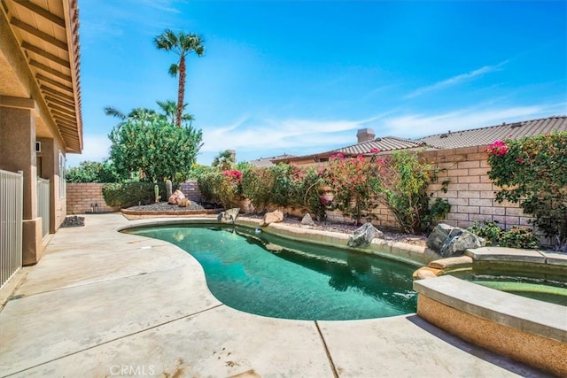 view of swimming pool featuring an in ground hot tub and a patio