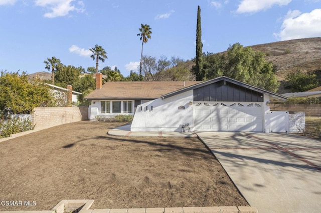 ranch-style home featuring a garage and a mountain view