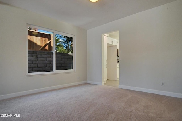 unfurnished room with light carpet