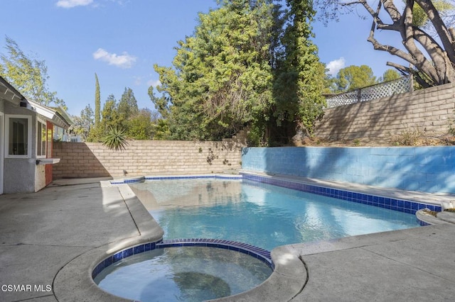 view of swimming pool with an in ground hot tub