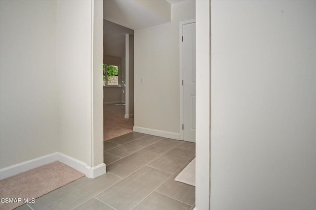 hall featuring light tile patterned floors