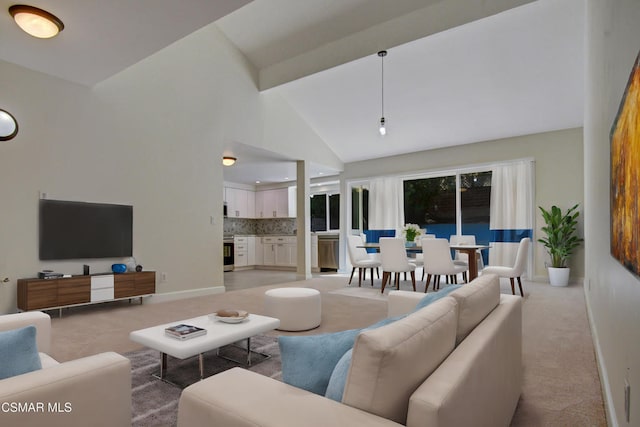 living room featuring light colored carpet and high vaulted ceiling