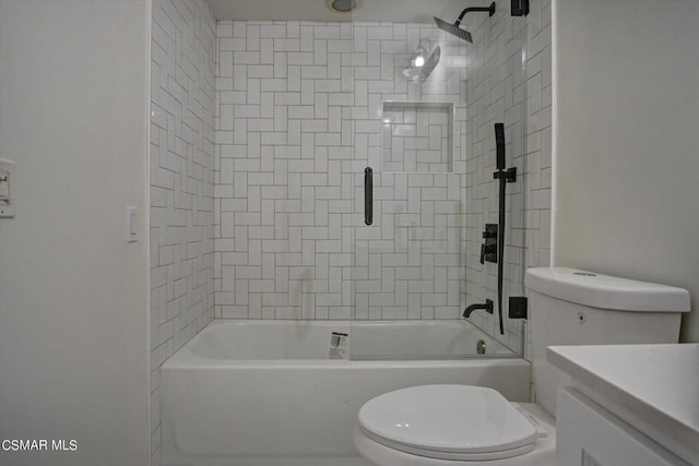 full bathroom with toilet, vanity, and tiled shower / bath combo