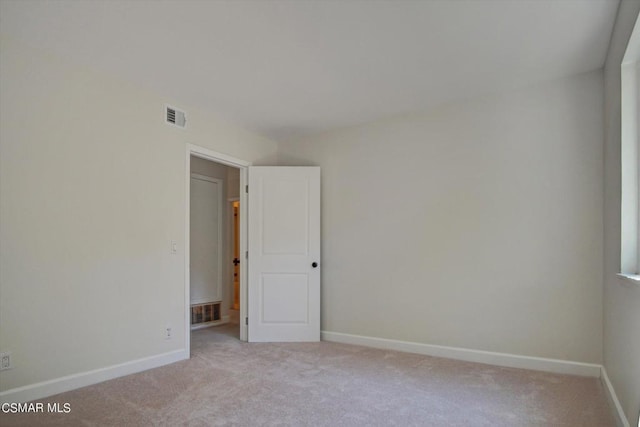 unfurnished room with light colored carpet