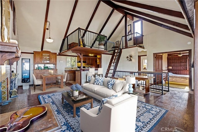 living room with high vaulted ceiling, beam ceiling, and a wealth of natural light