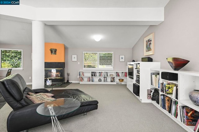 living room featuring a wealth of natural light, carpet, and lofted ceiling with beams