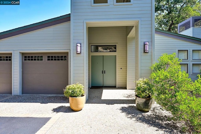 view of exterior entry featuring a garage