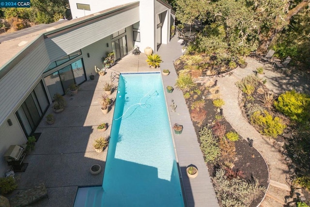 view of pool with a patio area and a wall unit AC