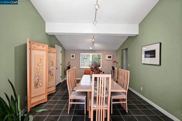 tiled dining area featuring vaulted ceiling with beams and track lighting