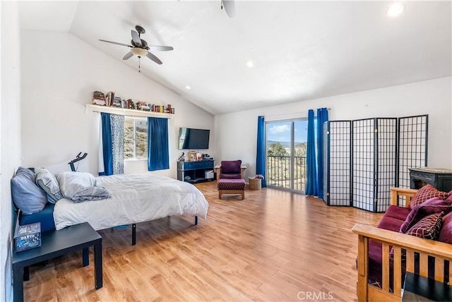 bedroom featuring hardwood / wood-style floors, ceiling fan, access to outside, and vaulted ceiling