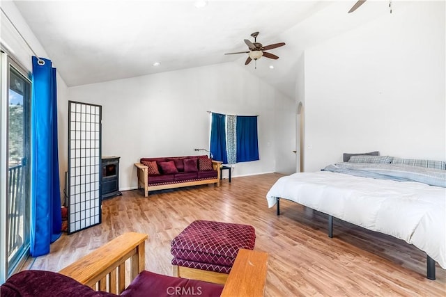 bedroom featuring light hardwood / wood-style flooring, ceiling fan, and lofted ceiling